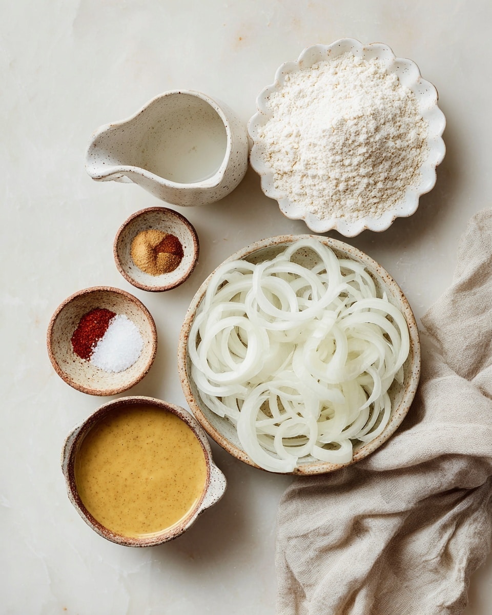 A round white speckled bowl is full of thin, curly fried onion rings that are golden brown with a crispy texture, sprinkled with coarse salt. The onion rings fill the bowl, forming a layered heap with some pieces overlapping each other. The bowl sits on a white marbled surface, and nearby are a small bowl of pinkish dipping sauce with visible bits inside, and a small bowl of coarse salt. A light-colored cloth napkin is partially visible in the corner. The scene is brightly lit, highlighting the crunchy texture of the onions and the fresh salt crystals, photo taken with an iphone --ar 4:5 --v 7