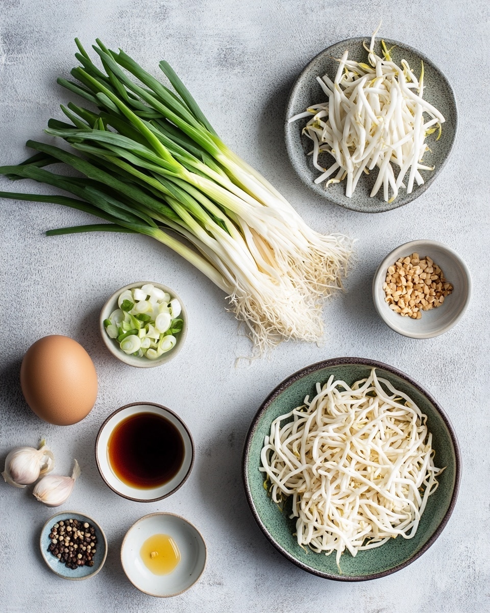 The image shows a white round plate filled with stir-fried noodles as the main layer, which are golden brown with a slightly shiny texture. Mixed in are thin, white bean sprouts and pieces of green leafy vegetables scattered evenly throughout, adding color contrast. The plate sits on a white marbled surface with a pink and white checkered cloth partially visible at the bottom left. At the top right corner, there are light pink chopsticks resting on the surface next to a white bowl filled with green edamame beans. In the upper left corner, a part of another white plate with more noodles and vegetables is visible. The overall view is top-down, with soft natural lighting highlighting the textures and colors. Photo taken with an iphone --ar 4:5 --v 7