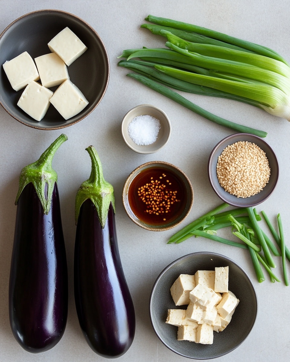 A close-up view of a silver pan filled with a rich, reddish-brown liquid curry that has visible oil on the surface. Inside the curry are large, irregular cubes of white tofu, long dark brown dried chili peppers, and small green pieces of chopped scallions scattered throughout. The curry base has a mix of textures with soft tofu and smooth broth, with some small floating bits that add a coarse texture. The pan is on a stove with a blurred white marbled surface in the background. Photo taken with an iphone --ar 4:5 --v 7