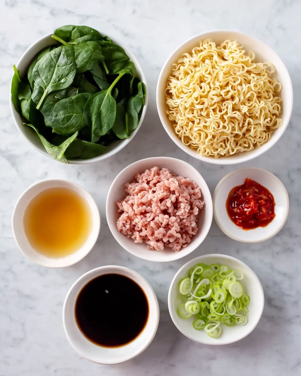 A white bowl filled with a rich brown broth holds four main toppings arranged in separate sections: dark green cooked leafy vegetables on the top left, a small pile of bright pink shredded garnish in the center, slightly curly yellow noodles on the right side, and crumbly brown ground meat with a few green onion slices scattered on top on the bottom left. A white soup spoon rests inside the bowl on the right side, and a pair of dark wooden chopsticks lie across the rim of the bowl. The bowl is placed on a white marbled surface. photo taken with an iphone --ar 4:5 --v 7