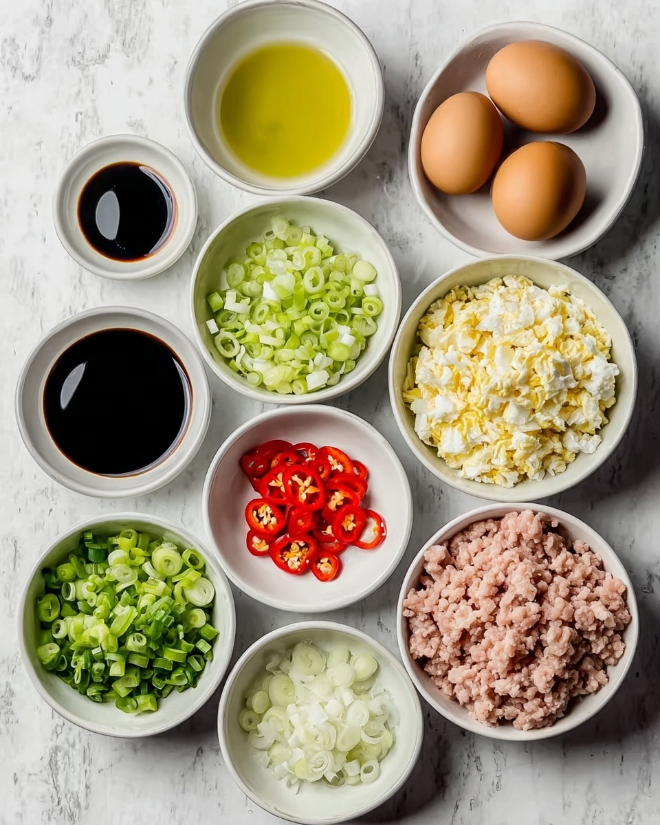 A flat lay of several white bowls and two eggs arranged on a white marbled surface. One bowl contains light pink ground meat with a crumbly texture, placed bottom right. Another bowl near the top right holds a mound of chopped hard-boiled eggs with white and yellow bits. Two whole brown eggs sit beside this bowl. There is a bowl of sliced green onions at the top center showing bright green rings. Below that, a bowl holds thinly sliced pale green leek rings. To the left, a smaller bowl contains diced white onions. Two bowls hold dark soy sauce with a smooth, glossy surface, positioned one above the other near the center. A small bowl at bottom left has thin red chili slices with visible seeds, and a bowl at top left contains golden yellow oil. All ingredients are neatly arranged and brightly lit, photo taken with an iphone --ar 4:5 --v 7